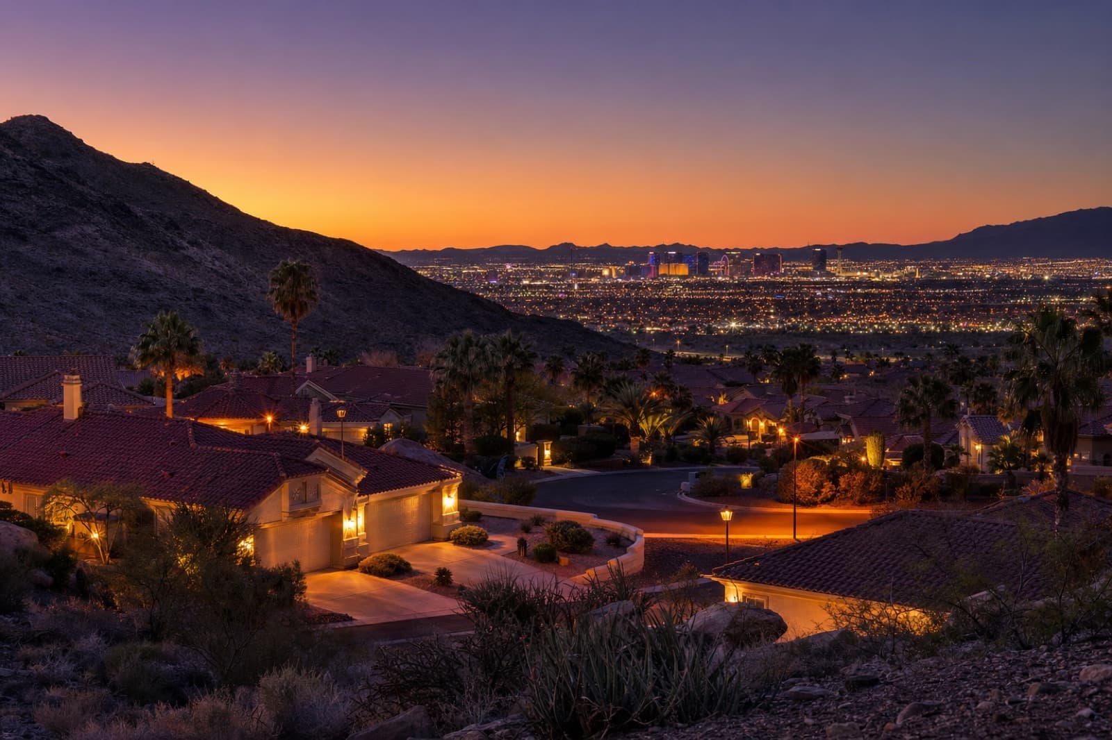 Twilight view of an established Las Vegas 55+ community showing mature landscape beside newer construction
