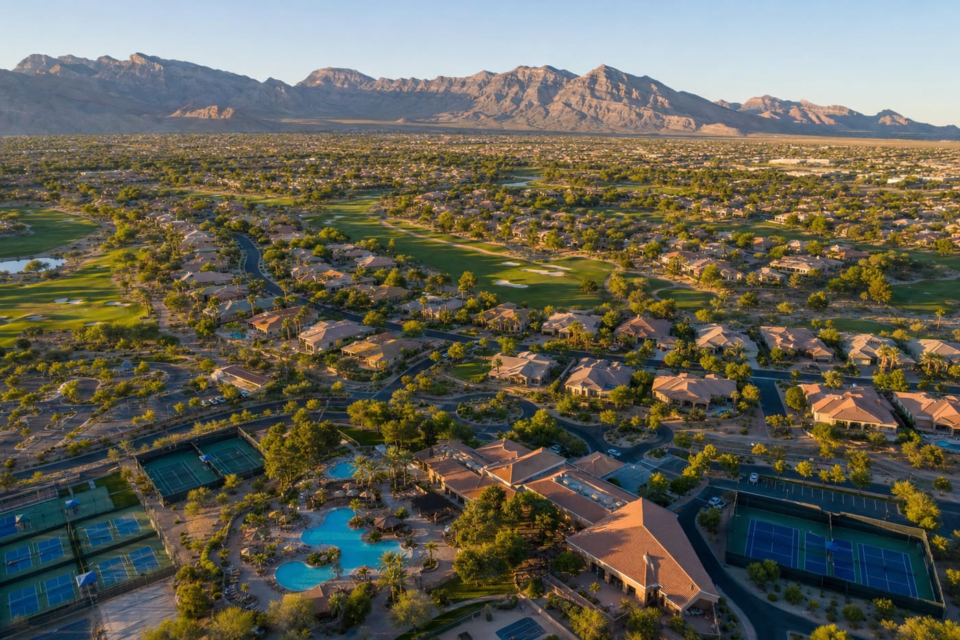 Aerial view of a Summerlin master-planned community with new-construction rooftops and desert mountains beyond